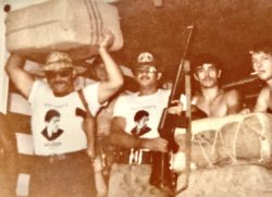 One of my favorite Keith photographs 1978 ninty pound bales of Columbian Carried out by the local sheriff with captain Tony T-shirts on a bunch of M-16s and the prisoners from the county jail helping to unload That weed was really amazing there is so many stories behind this photo